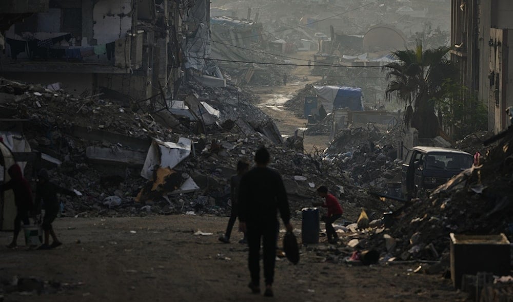 Palestinians walk through the destruction left by the Israeli air and ground offensive in Gaza City, Saturday, Nov. 29, 2025. (AP)
