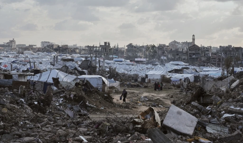 A tent camp for displaced Palestinians stands amid the destruction left by Israeli strikes north of Gaza City, Tuesday, November 25, 2025 (AP)