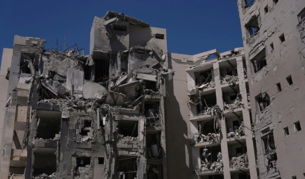 A heavily damaged building stands after a direct missile strike, launched from Iran, following the announcement of a ceasefire, in Beer al-Sabe, occupied Palestine, Wednesday, June 25, 2025 (AP)