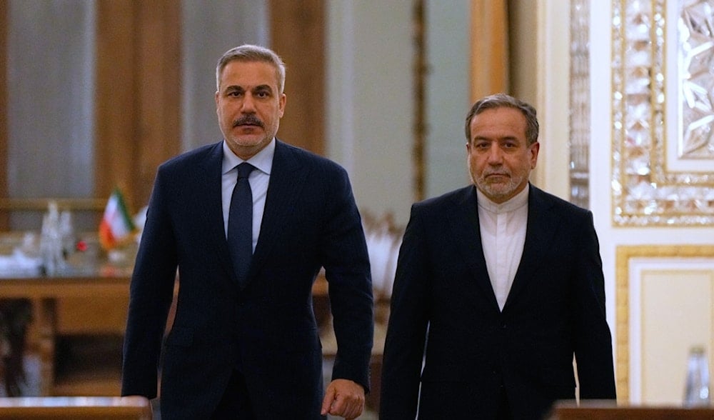 Iranian Foreign Minister Abbas Araghchi, right, and his Turkish counterpart Hakan Fidan arrive for a joint news briefing after their meeting, in Tehran, Iran, Sunday, Nov. 30, 2025. (AP)