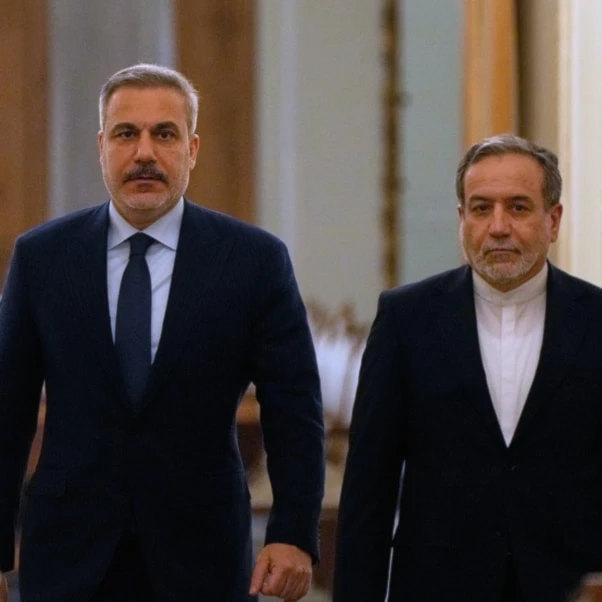 Iranian Foreign Minister Abbas Araghchi, right, and his Turkish counterpart Hakan Fidan arrive for a joint news briefing after their meeting, in Tehran, Iran, Sunday, Nov. 30, 2025. (AP)