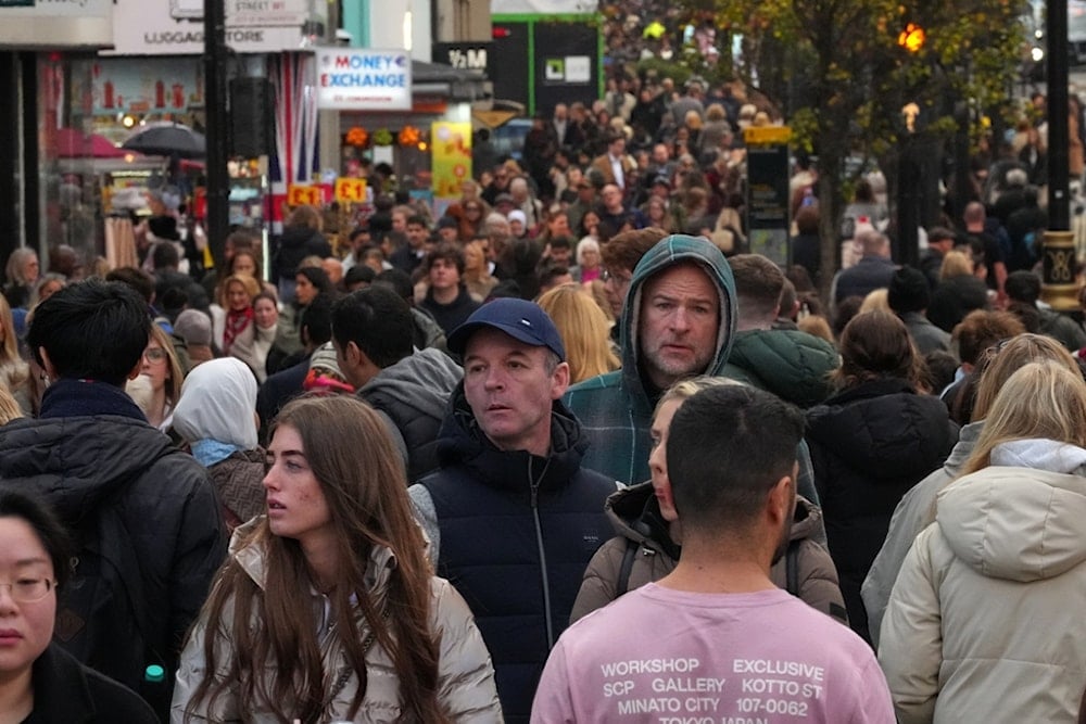 Shoppers walk along London's most famous shopping Street, Oxford Street, in London, the United Kingdom, Friday, November 28, 2025 (AP)