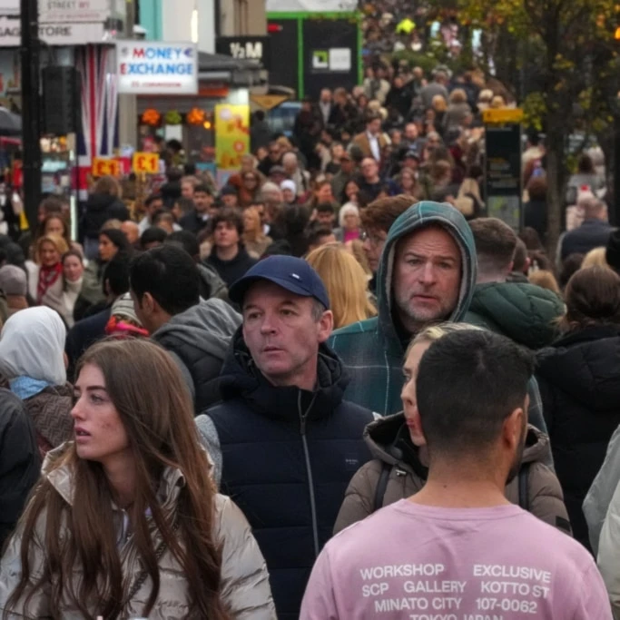 Shoppers walk along London's most famous shopping Street, Oxford Street, in London, the United Kingdom, Friday, November 28, 2025 (AP)