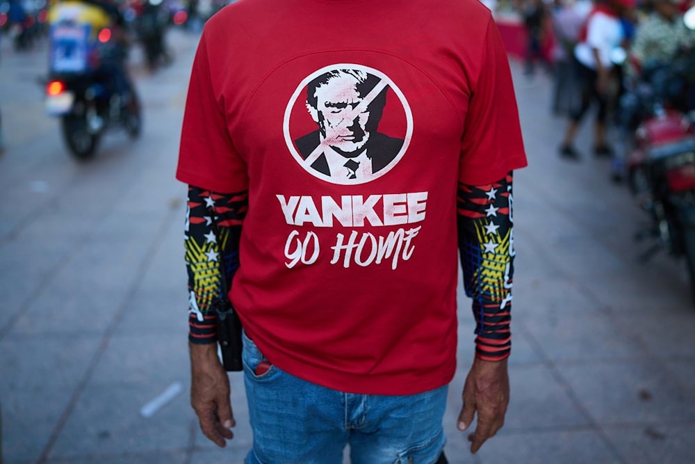 A man wears shirt with a image of US President Donald Trump during a government-organized rally against foreign interference, in Caracas, Venezuela, Thursday, Oct. 30, 2025. (AP)