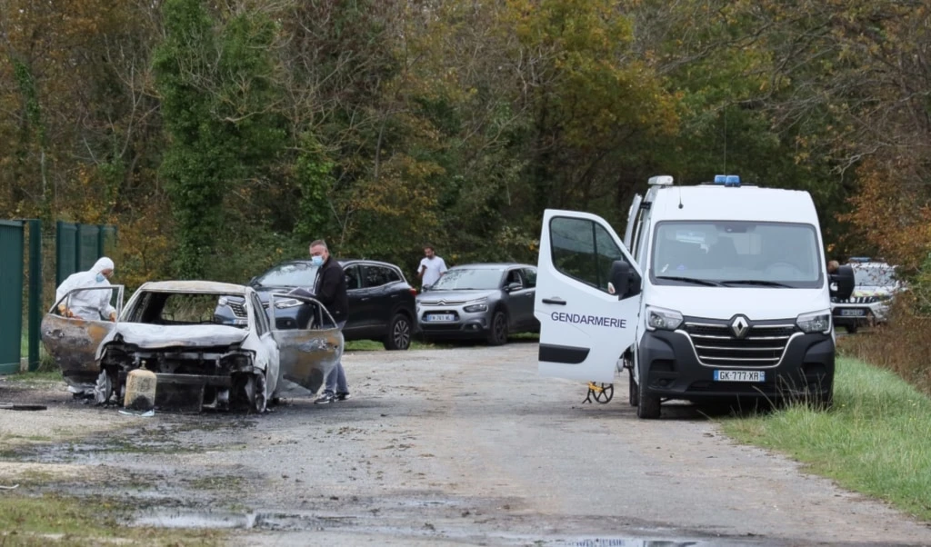 Investigators inspect the burned car after a motorist deliberately rammed pedestrians and cyclists across two neighboring towns on the Ile d'Oleron, Wednesday, November 5, 2025 (AP)