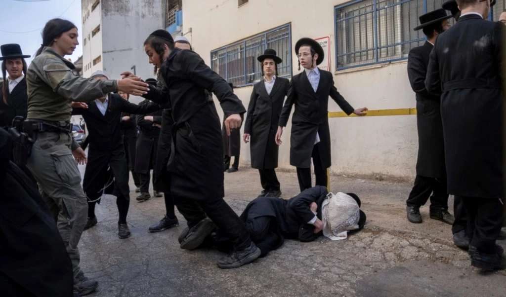 Israeli police officers scuffle with ultra-Orthodox Jewish men during a protest against a potential new draft law which could end their exemptions from military service in Jerusalem, Thursday, October 31, 2024. (AP Photo/Ohad Zwigenberg)