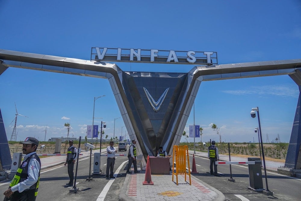 Private security stand guard at the entrance of the VinFast electric vehicle plant in Thoothukudi, in the southern Indian state of Tamil Nadu, Monday, Aug. 4, 2025. (AP Photo/Rafiq Maqbool)