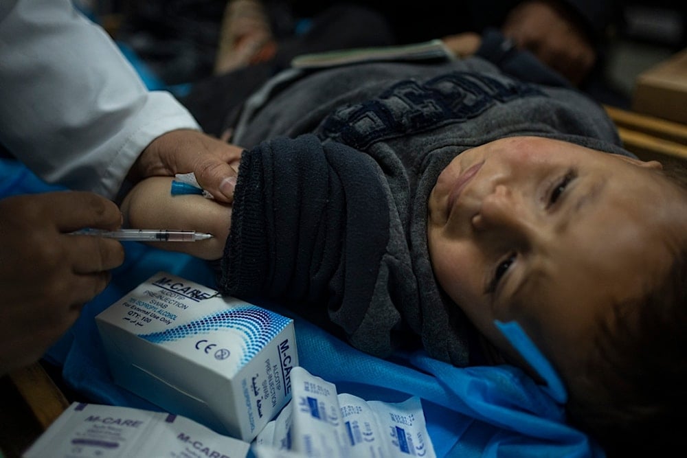 Palestinian children receive pentavalent vaccines in Rafah, Gaza Strip, Tuesday, January 2, 2024.  (AP Photo/Fatima Shbair)