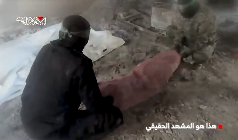 An Al-Qassam fighter filmed during the deception operation while Israeli drones survey the site, Gaza, 2025 (Screengrab)