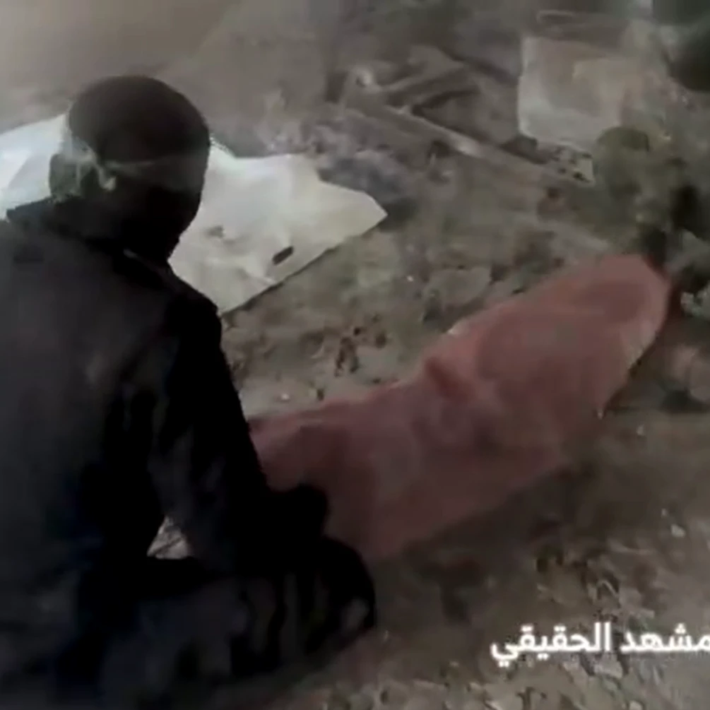 An Al-Qassam fighter filmed during the deception operation while Israeli drones survey the site, Gaza, 2025 (Screengrab)