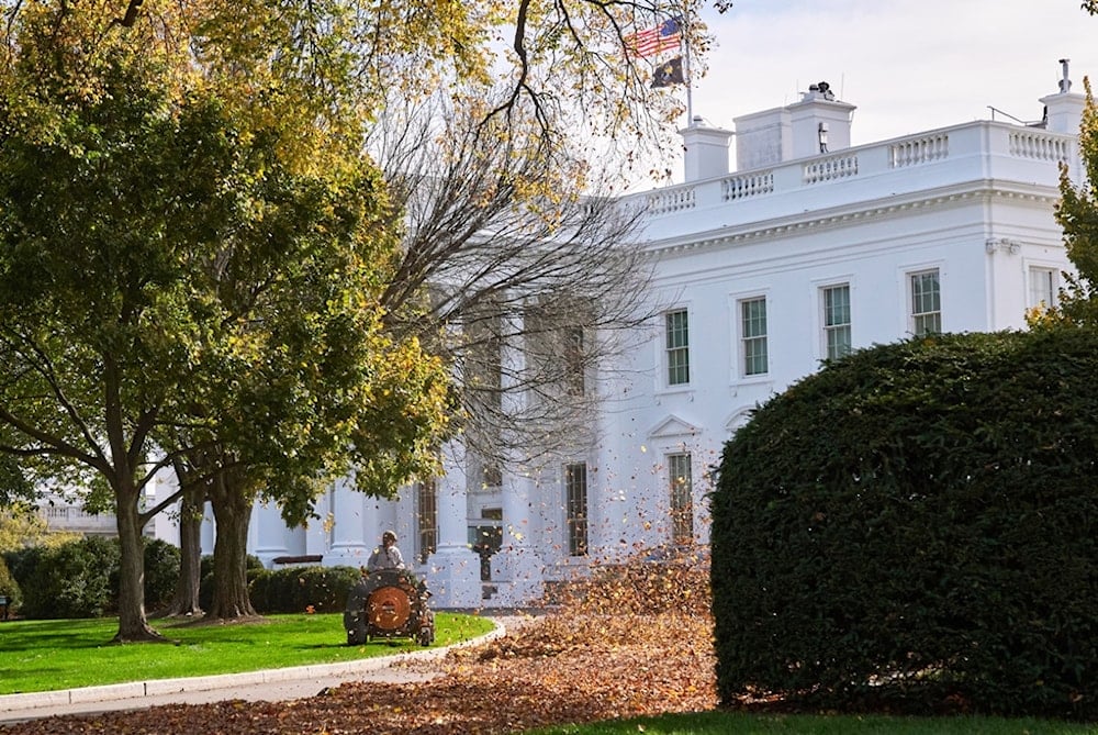 Leaves are blown from the North Lawn of the White House as the American flag is at half-staff, Thursday, November 4, 2025, in Washington. (AP Photo/Jacquelyn Martin)