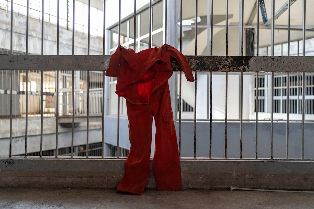 A prison jumpsuit is hung inside the Saydnaya military prison on the outskirts of Damascus, Syria, Sunday Jan. 12, 2025 (AP)