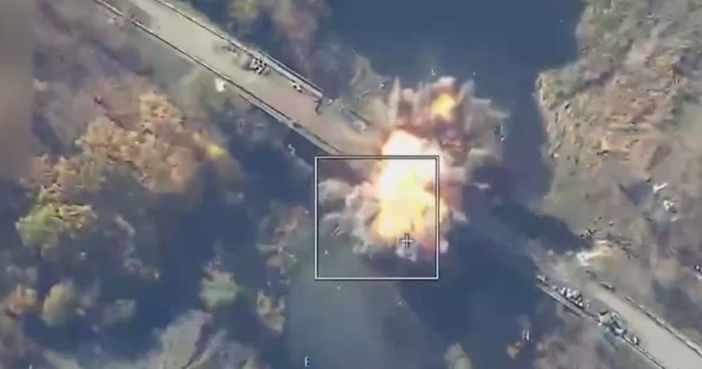 Smoke billows after a Russian airstrike targeting a bridge over the Volchya river, Ukraine, October 31, 2025 (Social Media)