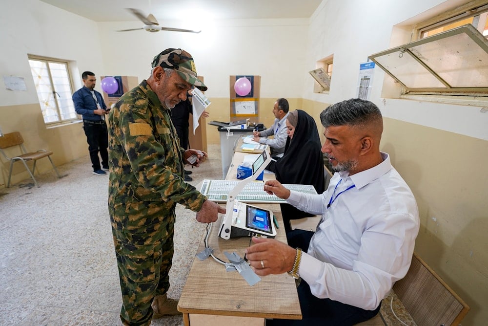 A member of the Popular Mobilization Forces casts his ballot during a special voting session ahead of Tuesday's parliamentary election in Najaf, Iraq, Sunday, Nov. 9, 2025 (AP)
