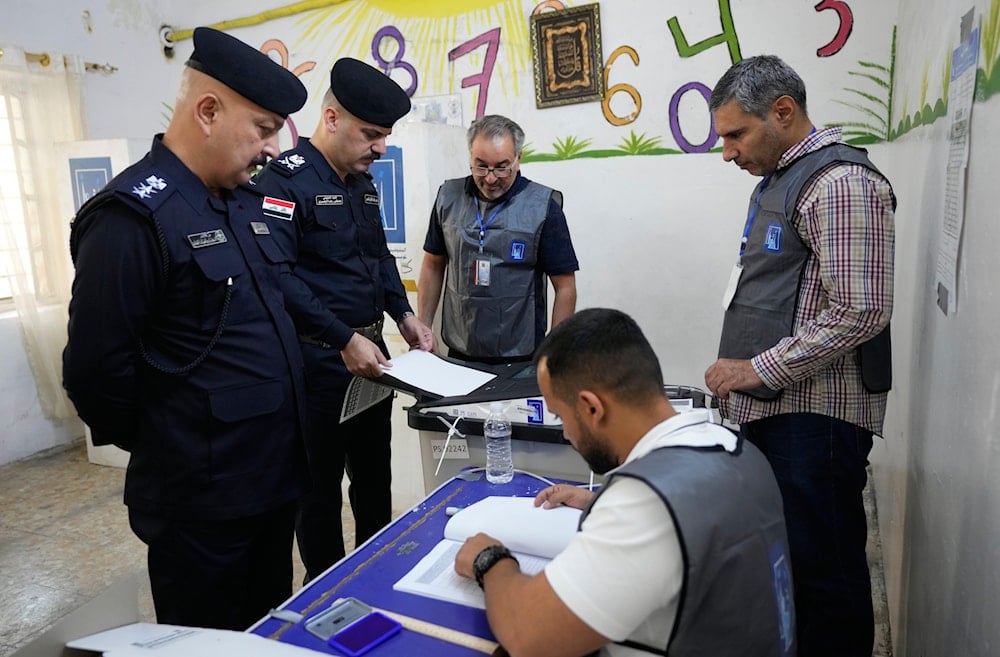 Iraqis policemen gather to vote during a special voting session ahead of Tuesday's parliamentary election in Baghdad, Iraq, on November 9, 2025. (AP Photo/Hadi Mizban)