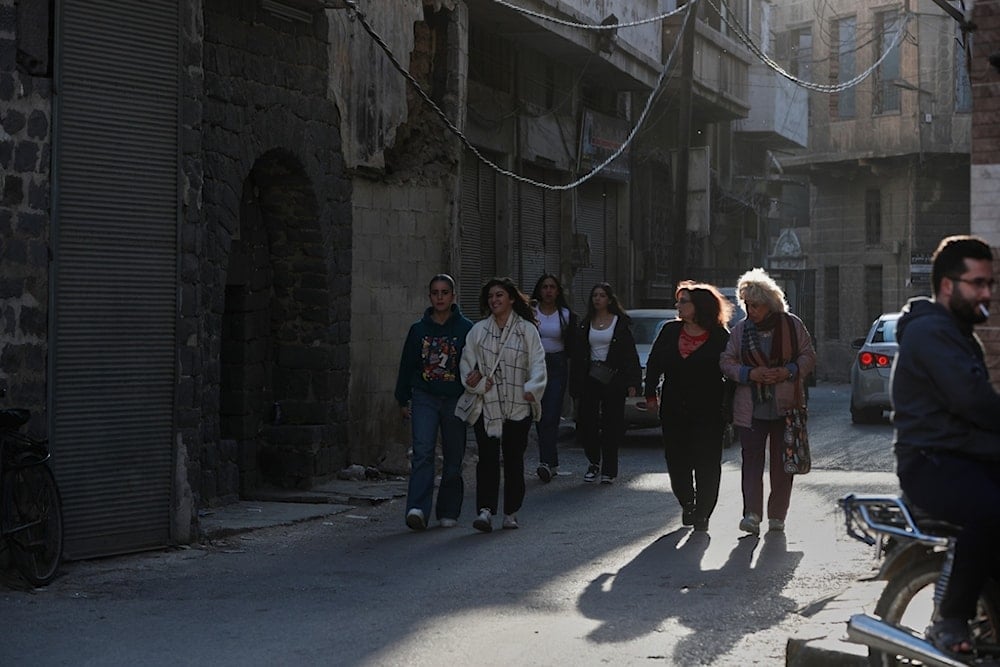 People walk through a street in the old city of Homs, Syria, Friday, November 21, 2025 (AP)