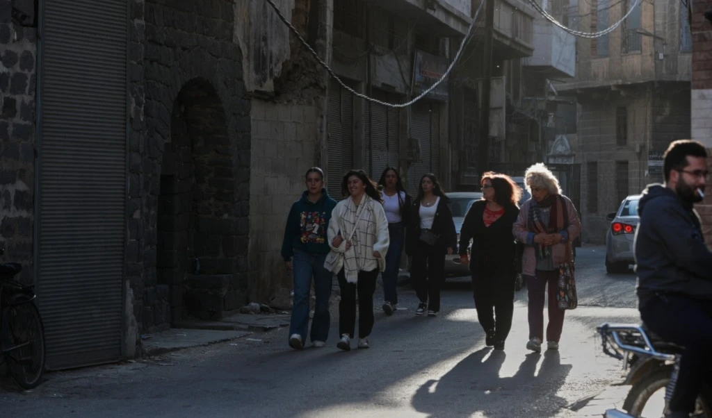 People walk through a street in the old city of Homs, Syria, Friday, November 21, 2025 (AP)