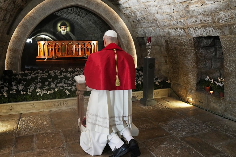 Pope Leo XIV prays in front of the tomb of Saint Charbel Makhlouf at the Monastery of Saint Maroun, in Annaya, Lebanon, Monday, Dec. 1, 2025 (AP)