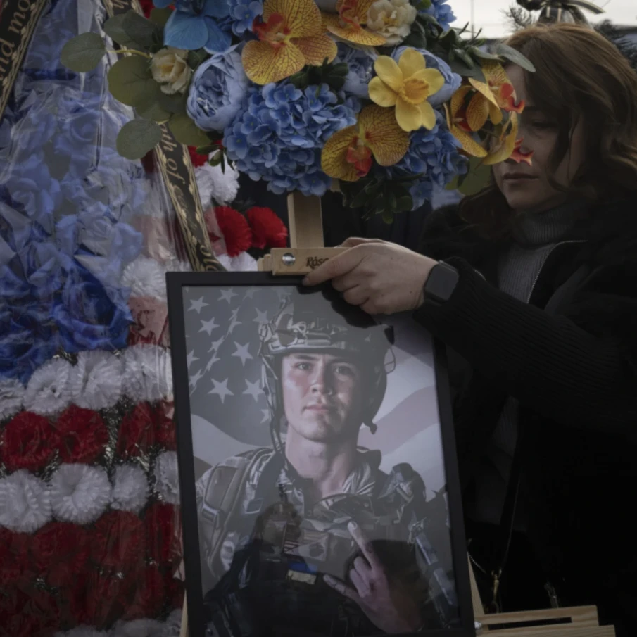 A woman holds a portrait of US Marine Corps veteran Ethan Hertweck who was killed in Ukraine during a funeral ceremony in Kiev, Ukraine on February 28, 2025. (AP)