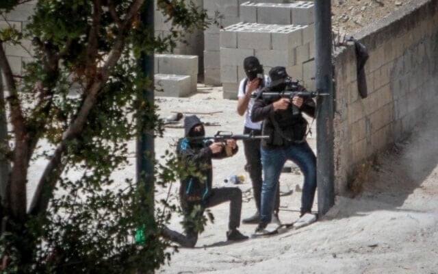 Armed Palestinian fighters take up positions and exchange fire with Israeli forces during clashes in the West Bank. (Social media)
