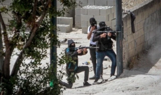Armed Palestinian fighters take up positions and exchange fire with Israeli forces during clashes in the West Bank. (Social media)