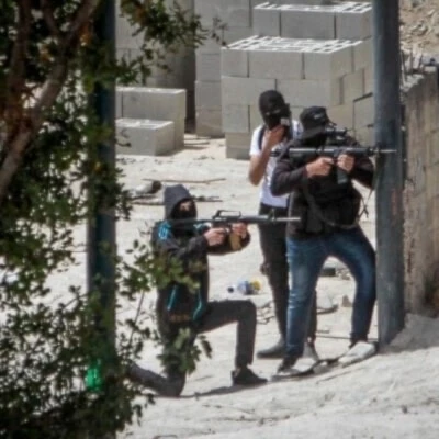 Armed Palestinian fighters take up positions and exchange fire with Israeli forces during clashes in the West Bank. (Social media)