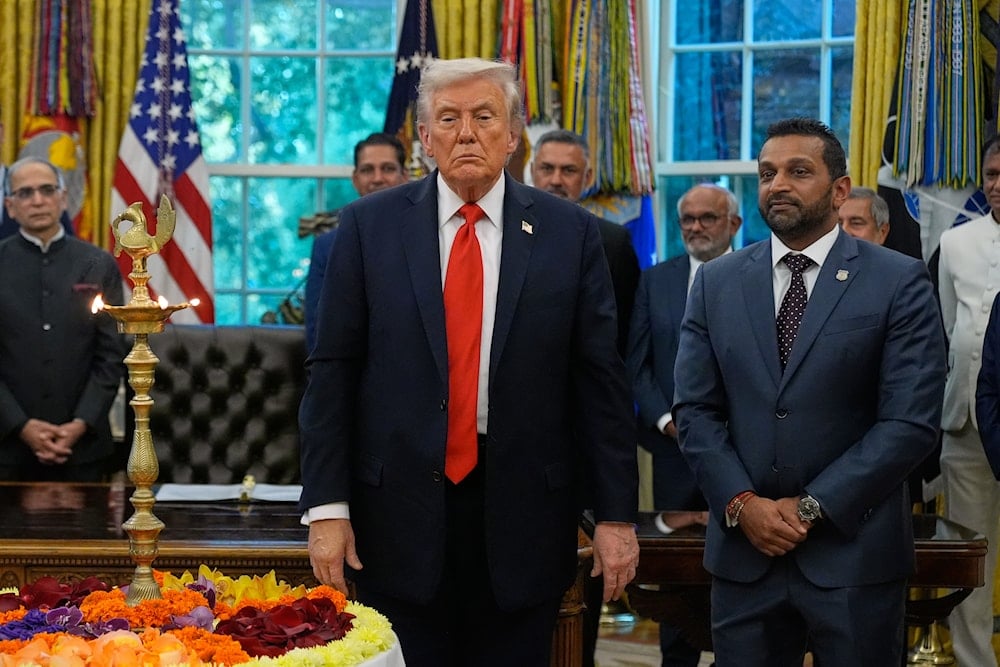 President Donald Trump stands with FBI director Kash Patel as he participates in a Diwali celebration in the Oval Office at the White House, Tuesday, Oct. 21, 2025, in Washington (AP)