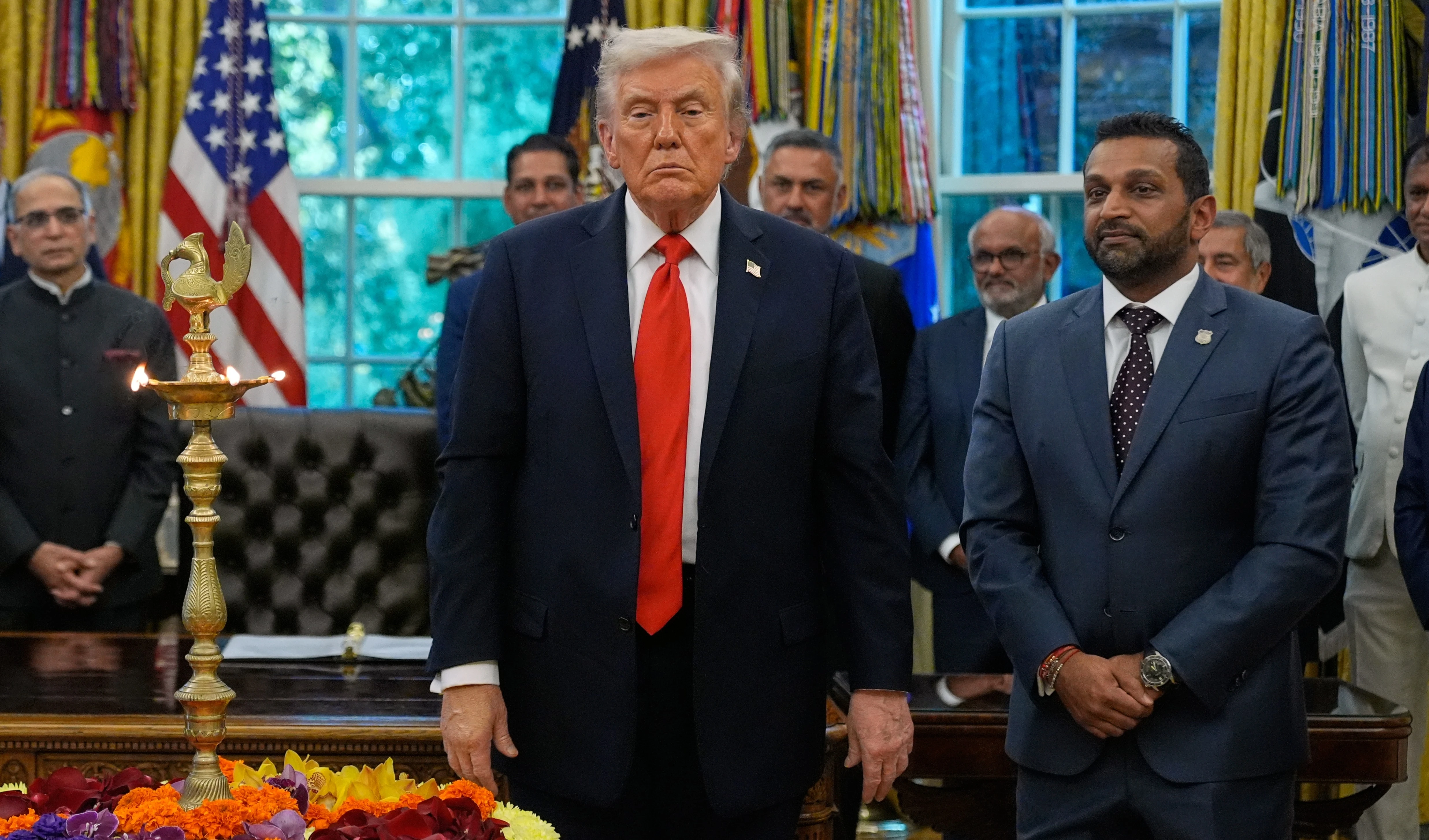 President Donald Trump stands with FBI director Kash Patel as he participates in a Diwali celebration in the Oval Office at the White House, Tuesday, Oct. 21, 2025, in Washington (AP)