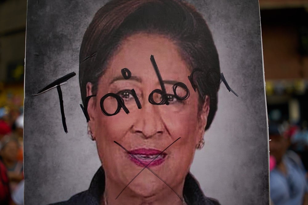 A poster of Trinidad and Tobago Prime Minister Kamla Persad-Bissessar hosts the Spanish word for 