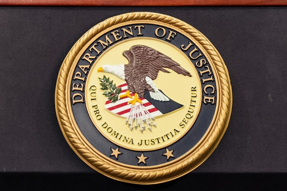 The Department of Justice logo is seen on a podium during a press conference at the US Attorney's Office, Oct. 23, 2025, in New York (AP)