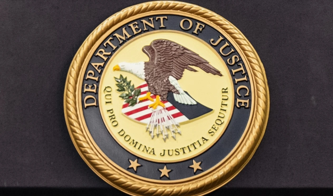 The Department of Justice logo is seen on a podium during a press conference at the US Attorney's Office, Oct. 23, 2025, in New York (AP)