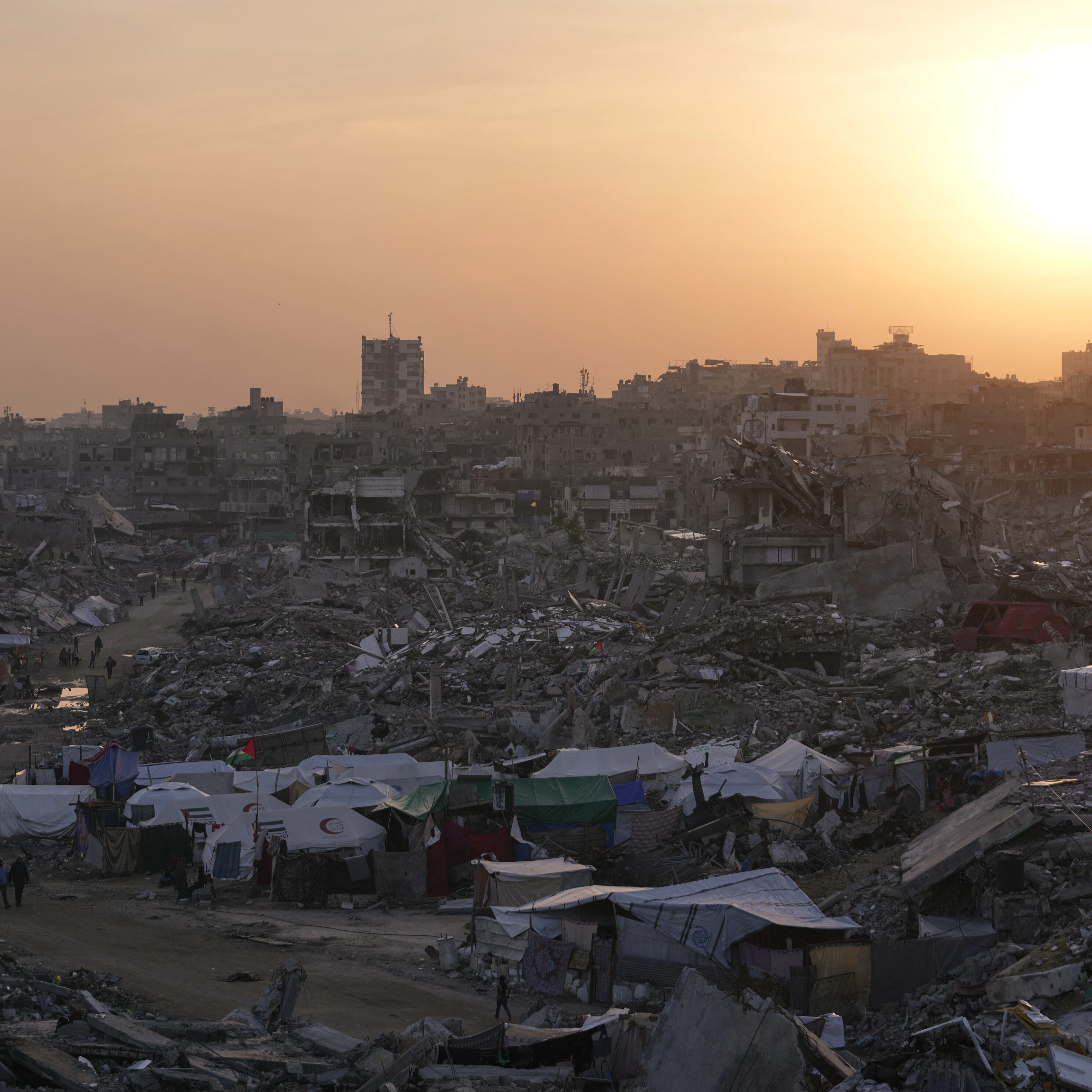 Tents sheltering displaced Palestinians stand amid the destruction left by the Israeli air and ground offensive in Gaza City Friday, Nov. 28, 2025 (AP)