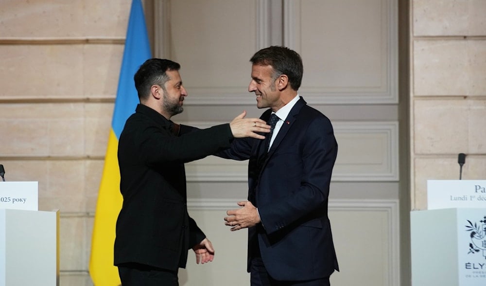 French President Emmanuel Macron, right, and Ukrainian President Volodymyr Zelenskyy hug each other after a joint press conference at the Elysee Palace in Paris, Monday, Dec 1, 2025. (AP)