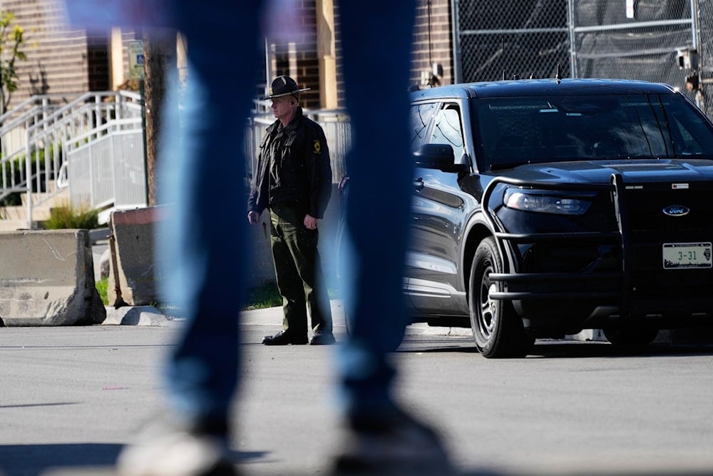 A Illinois State Police officer stands outside an ICE (U.S. Immigration and Customs Enforcement) processing facility in the Chicago suburb of Broadview, Ill., on October 21, 2025. (AP Photo/Nam Y. Huh)
