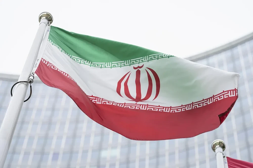 The flag of Iran waves in front of the headquarters of IAEA in Vienna, May 24, 2021. (AP)