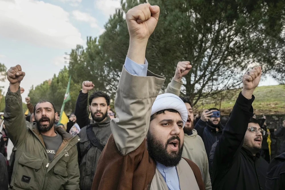 Southerners shout slogans against Israeli invading units blocking a road leading their homes in the southern village of Maroun el-Rass, Monday January 27, 2025. (AP)