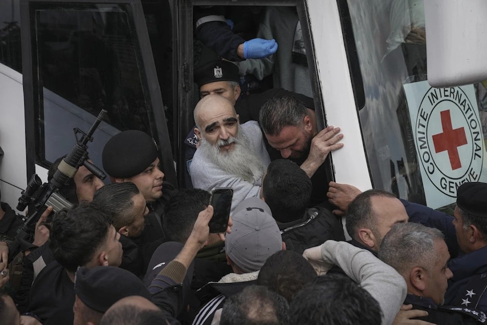 A Palestinian detainee is help to exit a Red Cross bus after being released from Israeli prisons in the West Bank city of Ramallah, Saturday February 1, 2025. (AP)