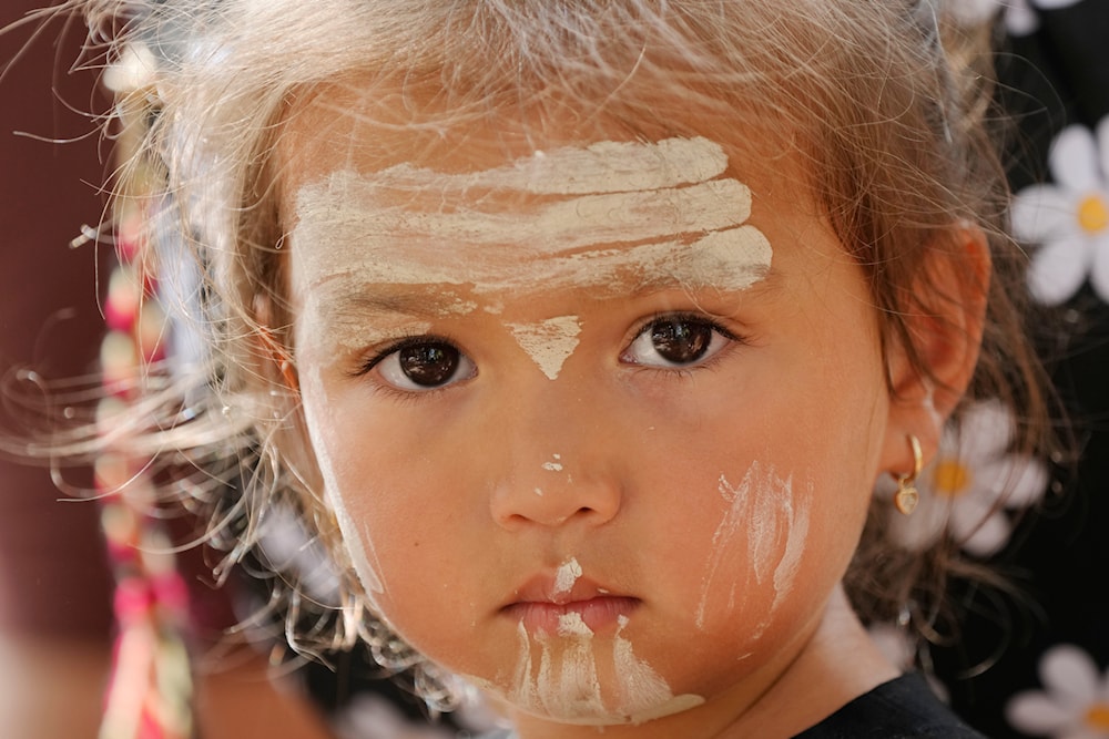 Elouera Dephoff, 2, has traditional paint adornments on her face while attending an Indigenous Australians protest during Australia Day in Sydney, Friday, Jan. 26, 2024. (AP)