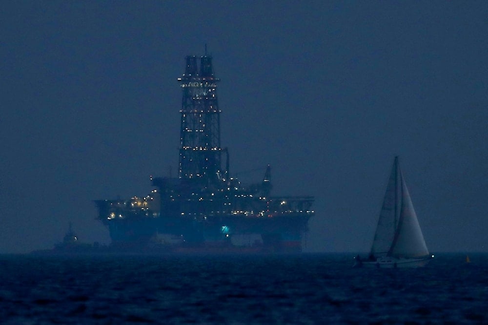 An offshore drilling rig stands in the waters off Cyprus' coastal city of Limassol, July 5, 2020, as a sailboat navigates in the foreground (AP)