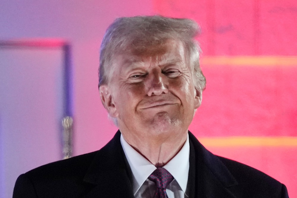  US President Donald Trump smiles after a fireworks show at Trump National Golf Club in Sterling, Va., Saturday, Jan. 18, 2025, ahead of the 60th Presidential Inauguration. (AP)