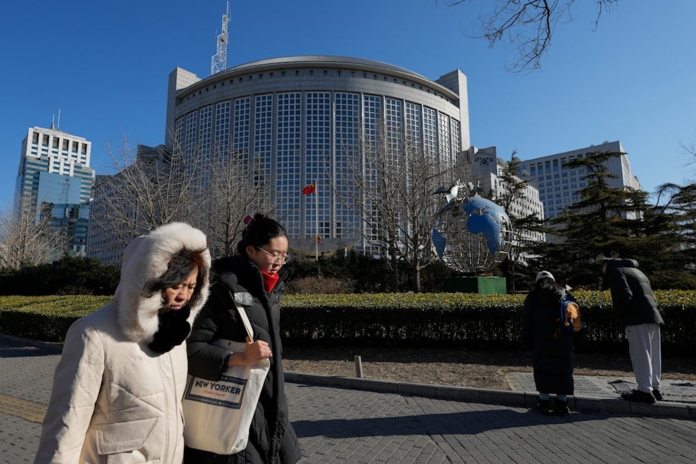 People walk by the Ministry of Foreign Affairs office in Beijing, Wednesday, Feb. 5, 2025. (AP)