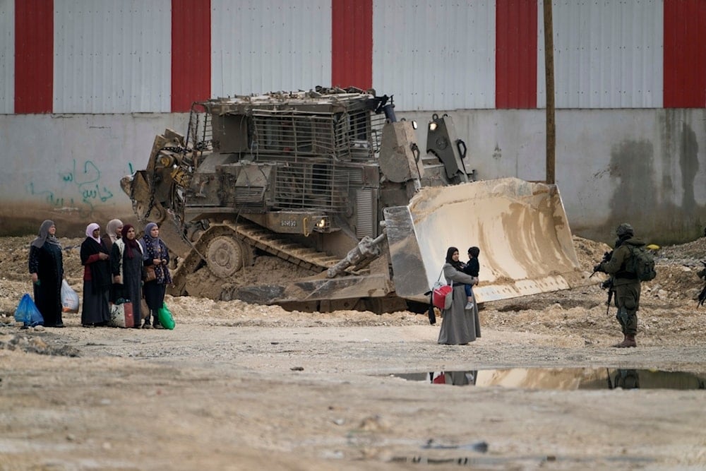 Israeli soldiers check the ID of Palestinians in the West Bank refugee camp of Nur Shams, Tulkarem, as the Israeli military continues to ravage the area on Tuesday, Feb. 11, 2025. (AP)