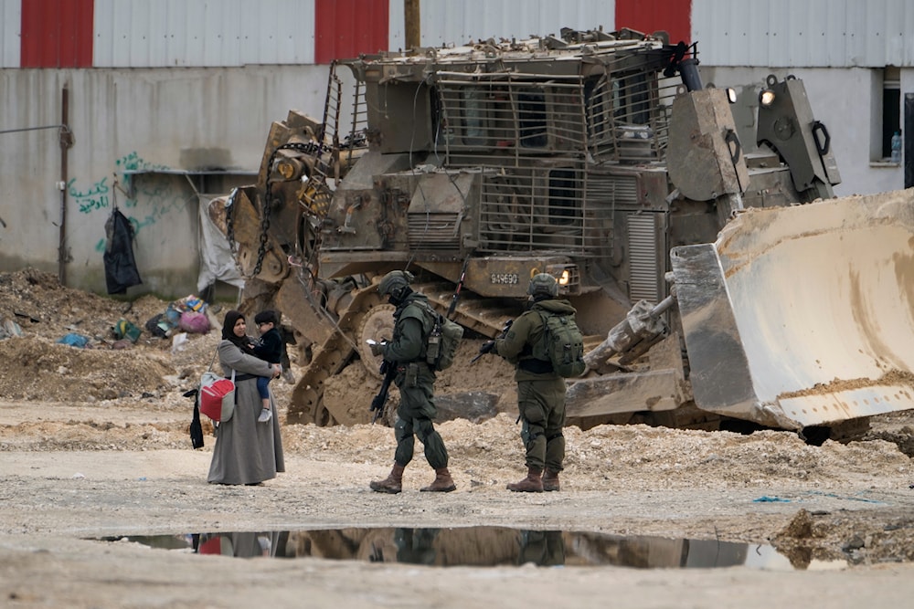 Israeli Occupation Forces (IOF) check the ID of Palestinians in the West Bank refugee camp of Nur Shams, Tulkarm, as the Israeli military continues its brutal aggression in the area on Tuesday, Feb. 11, 2025. (AP)