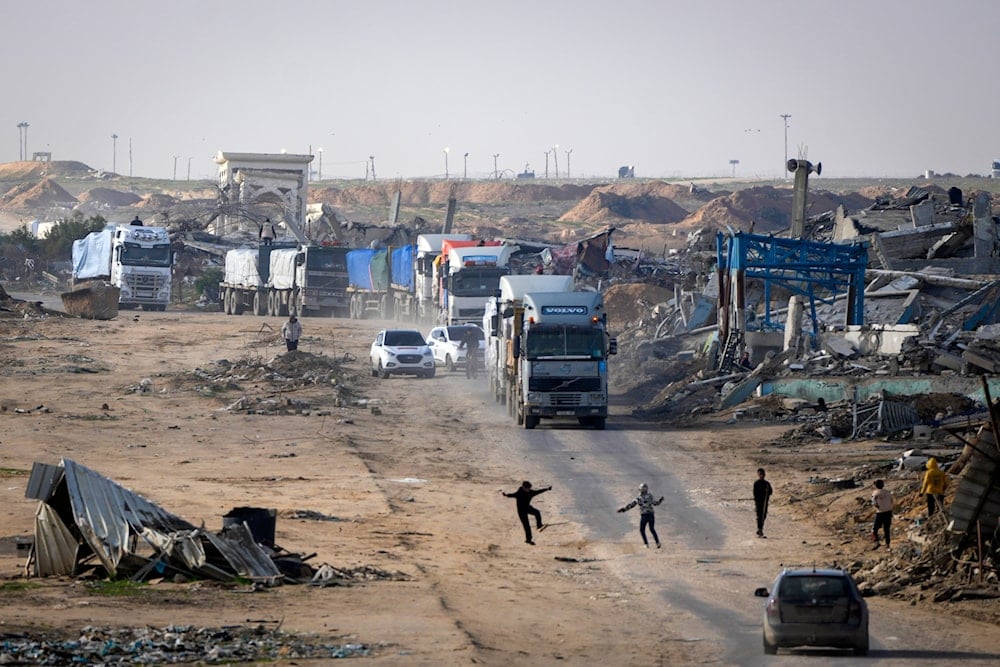 Trucks carrying humanitarian aid enter the Gaza Strip from Egypt in the southern Gaza town of Rafah, Wednesday, Feb. 12, 2025 (AP)