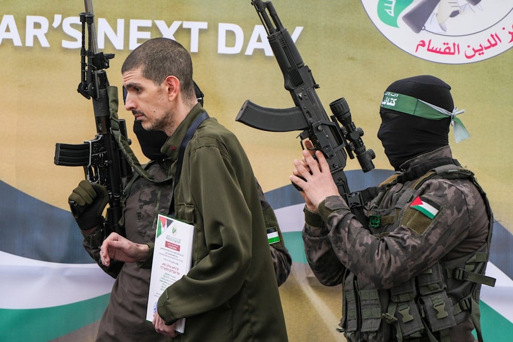 Israeli captive Or Levy, who has been held hostage by Hamas in Gaza since October 7, 2023, is escorted by Hamas fighters (AP)