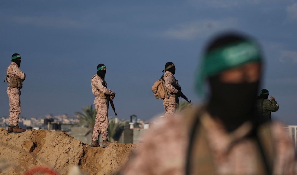 Hamas fighters take up positions ahead of the release of a captive as he is being handed over to the Red Cross in Khan Younis, southern Gaza Strip, Saturday, Feb. 1, 2025. (AP)