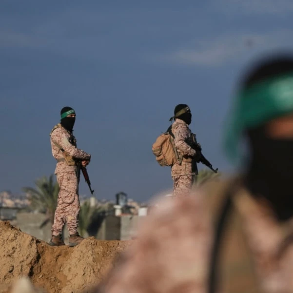 Hamas fighters take up positions ahead of the release of a captive as he is being handed over to the Red Cross in Khan Younis, southern Gaza Strip, Saturday, Feb. 1, 2025. (AP)