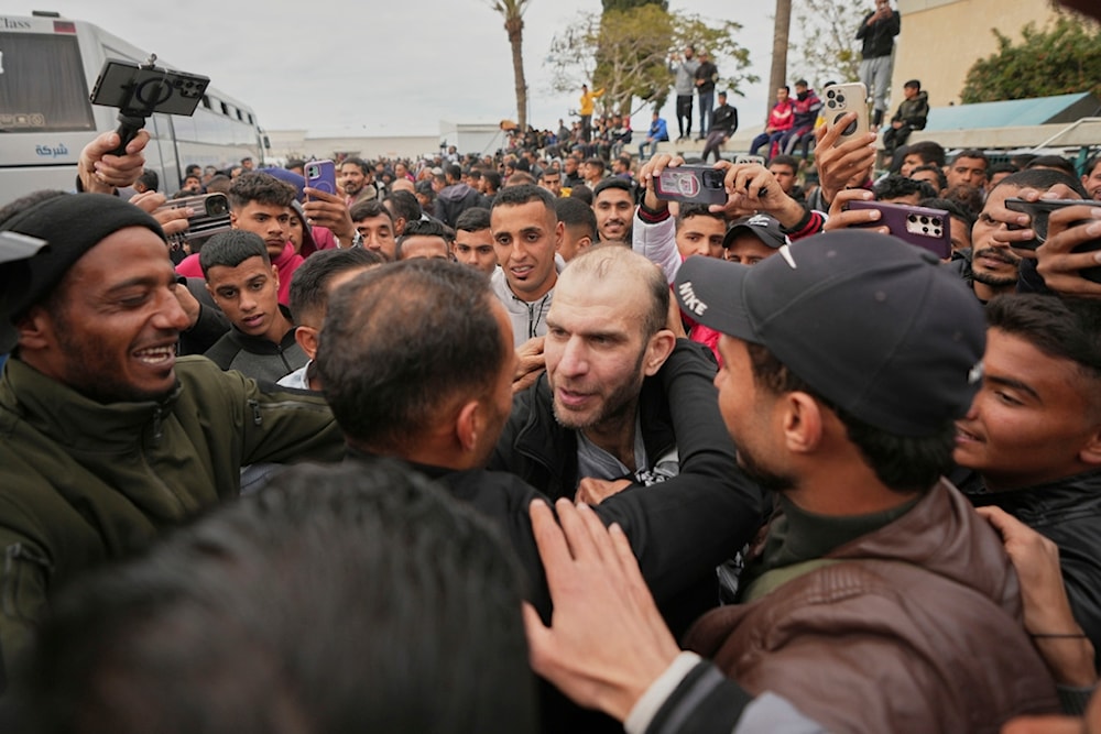 Freed Palestinian prisoner Ammar al-Daghma, 42, is greeted by a crowd as he arrives in the Gaza Strip after being released from an Israeli prison following a ceasefire agreement in Khan Younis, Gaza Strip, Saturday, Feb. 8, 2025 (AP)