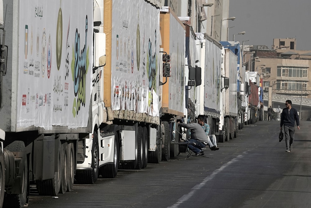 Truck drivers of humanitarian aid wait at a parking point in Cairo, Egypt, on their way to cross the Rafah border crossing between Egypt and the Gaza Strip, Sunday, Jan. 26, 2025 (AP)