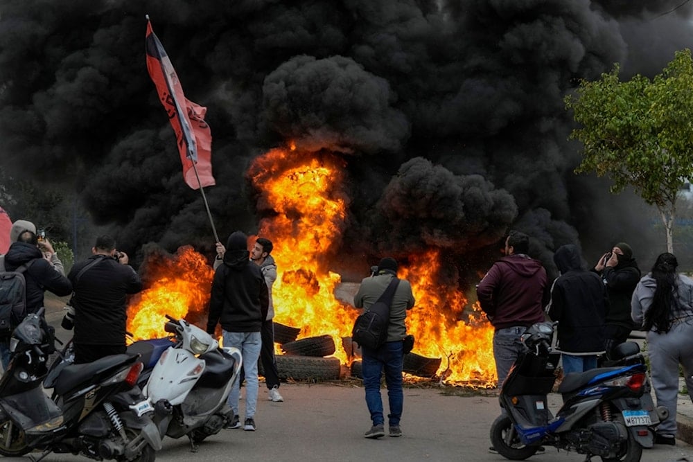 Lebanese protesters burn tires to block a road link to the international airport during a protest against statements made by US deputy special envoy for Middle East peace Morgan Ortagus in Beirut, Lebanon, Friday, Feb. 7, 2025